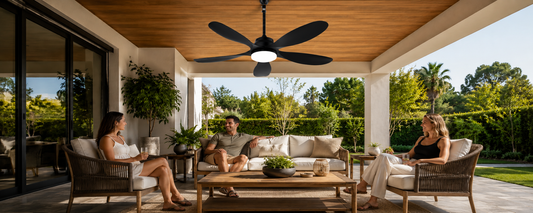Black solar ceiling fan with light over covered patio lounge for no-wiring outdoor cooling