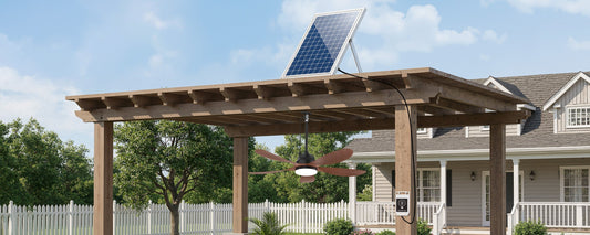Solar ceiling fan with separate solar panel mounted above a wooden pergola in direct sunlight