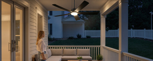 Solar ceiling fan with LED light installed on a covered patio for evening outdoor seating