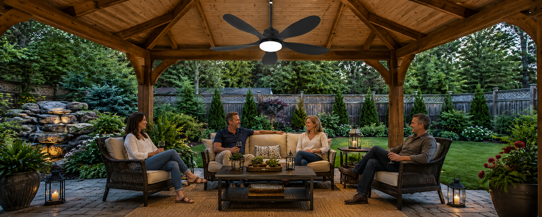 Solar ceiling fan with light cooling a covered backyard patio seating area after sunset
