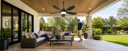 Black solar ceiling fan with light installed above a shaded covered patio seating area with guests