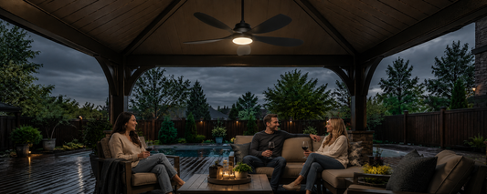 alt="Solar ceiling fan with light running in a covered gazebo on a cloudy evening by the pool"