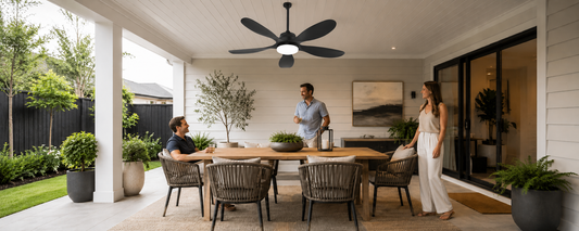 Black solar ceiling fan with light above a covered porch dining area