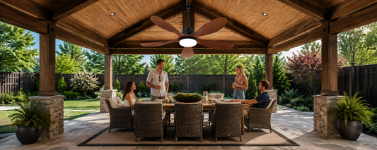 Solar ceiling fan with light installed above an outdoor dining area in a wooden backyard pavilion