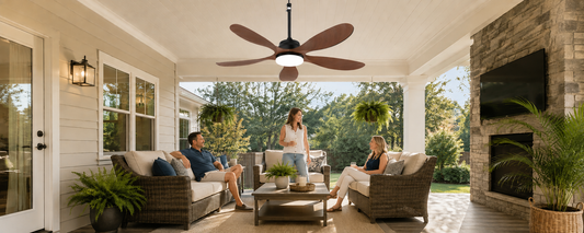 Outdoor ceiling fan with light above a covered patio seating area for summer cooling
