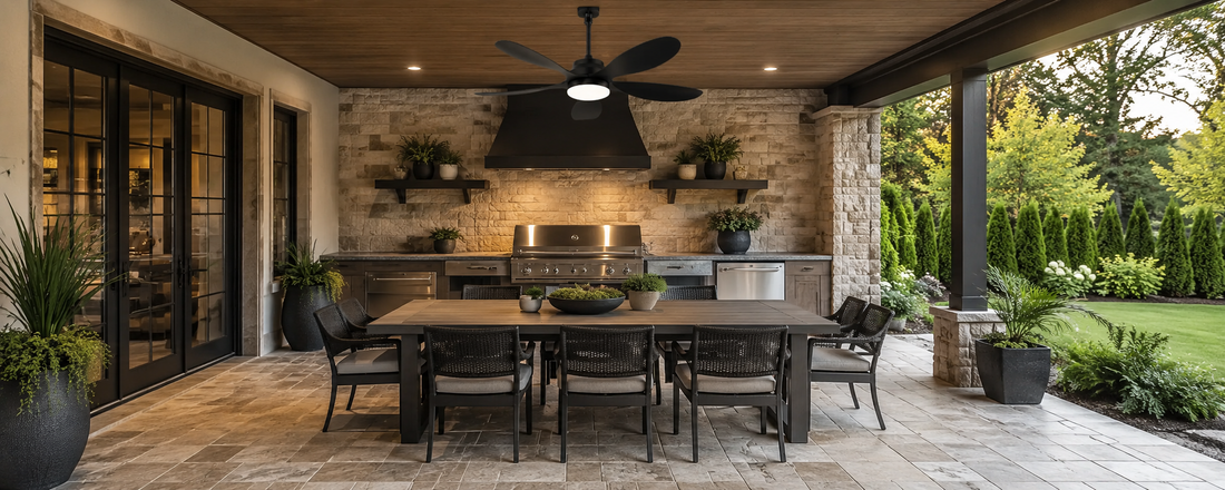 Black solar ceiling fan with light over a covered patio dining area and outdoor kitchen