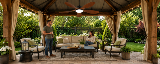 Ventallion solar ceiling fan with LED light installed on a covered patio lounge for no-wiring outdoor comfort