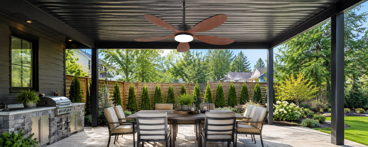 Outdoor solar ceiling fan mounted to a structural beam under a metal pergola roof