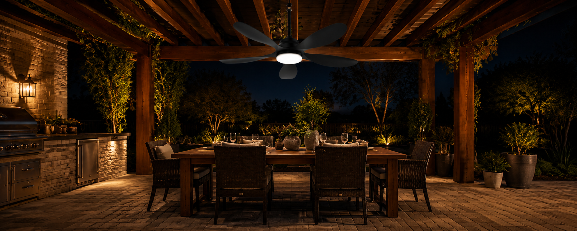 Solar panel charging a battery backed solar ceiling fan installed under a pergola at night