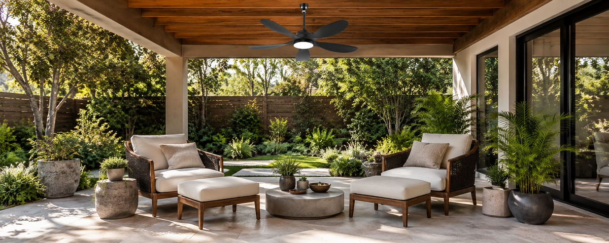 Black 52-inch outdoor solar ceiling fan with light over a covered patio seating area