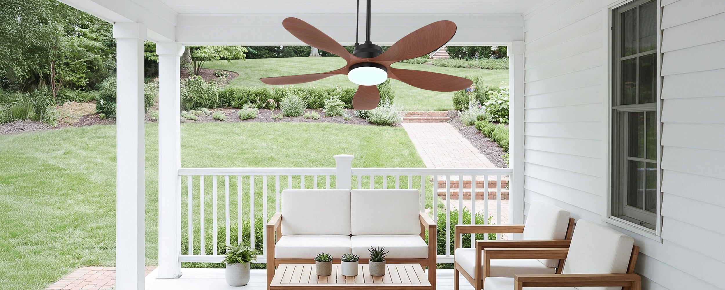 Covered porch seating area with an outdoor ceiling fan under a solid roof