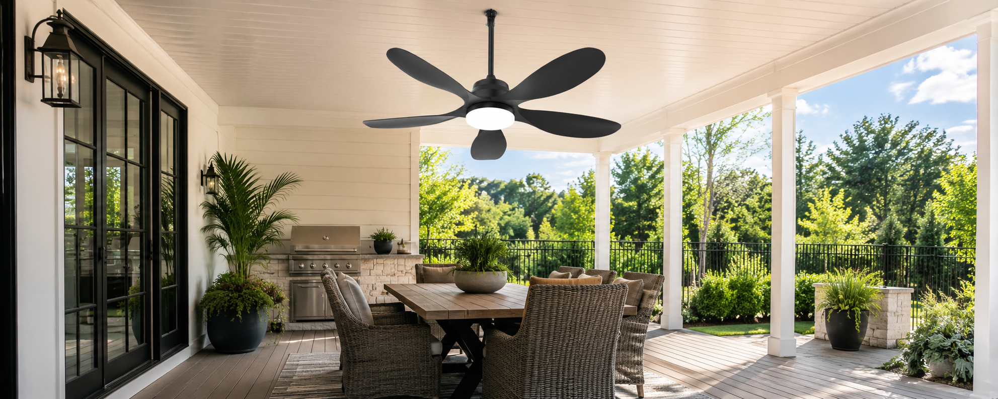 Outdoor solar ceiling fan with light over a covered patio dining area for airflow and lighting control