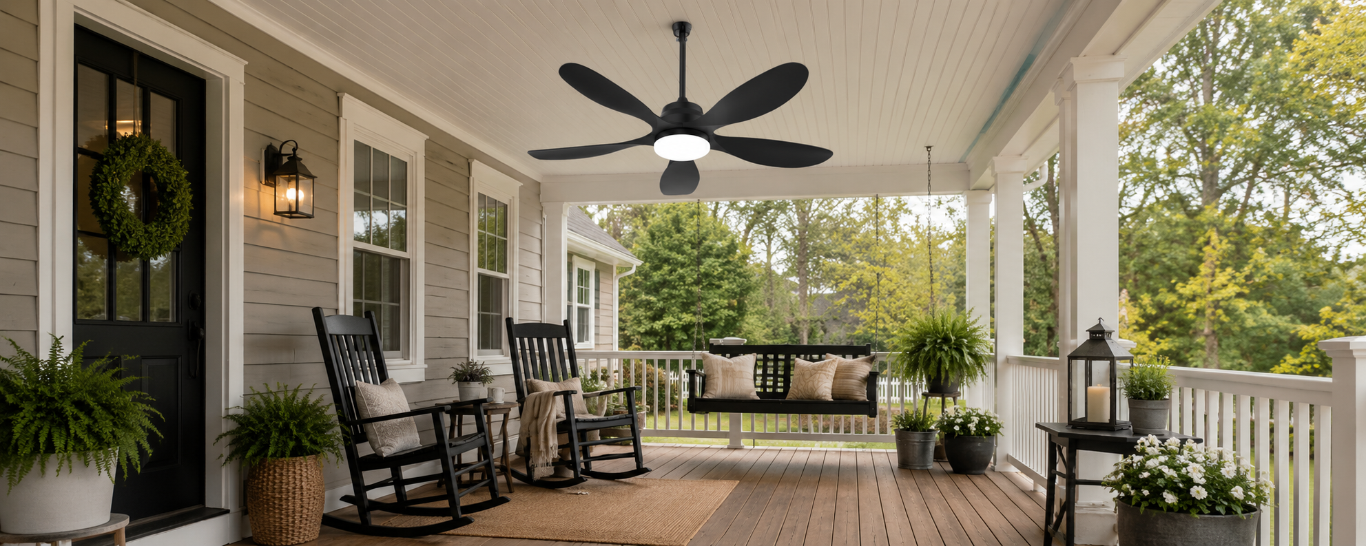 Portable outdoor fan with a visible charging cord beside covered patio furniture