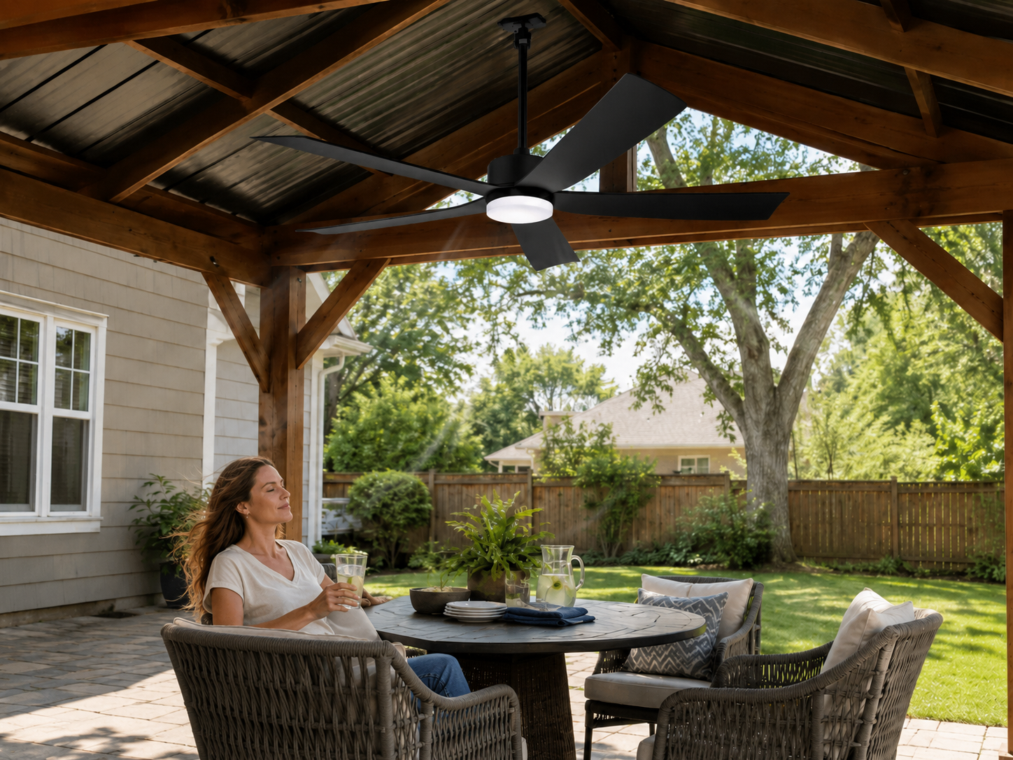 Solar gazebo fan installed above outdoor seating area for better airflow