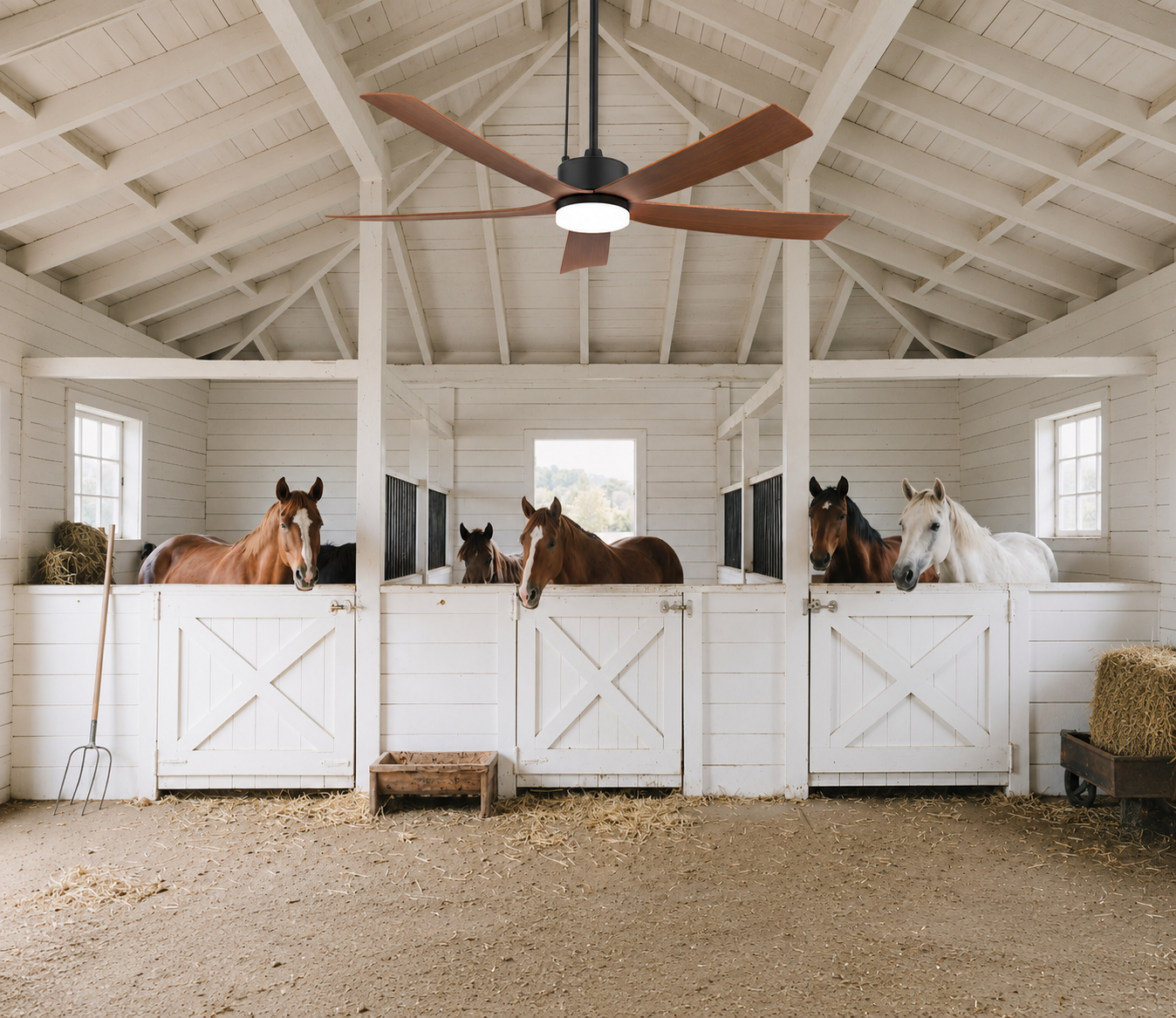 solar ceiling fan for barns and stables with LED light in covered stable aisle