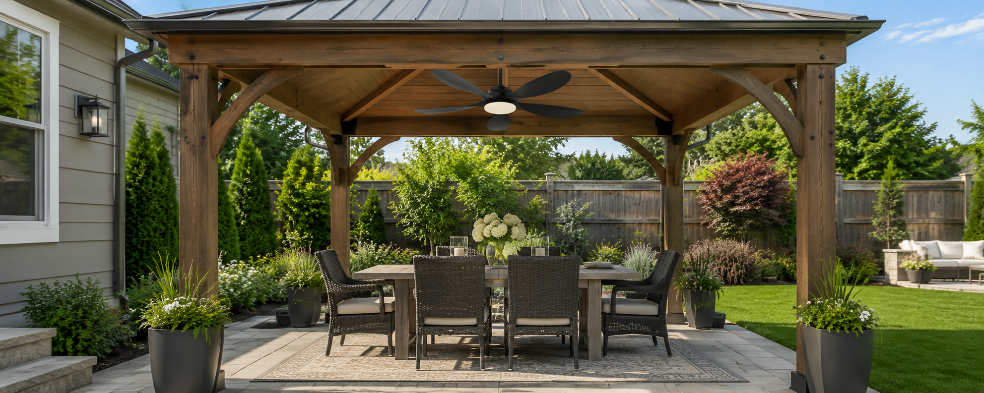 Solar gazebo fan with light over a covered wooden outdoor dining area
