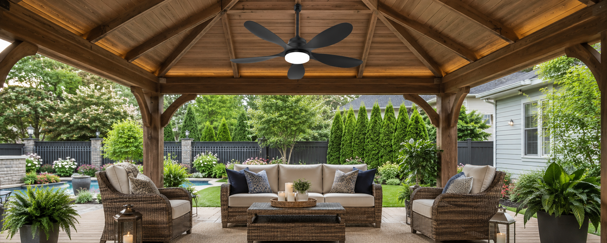 Black solar ceiling fan with light in a covered poolside gazebo lounge